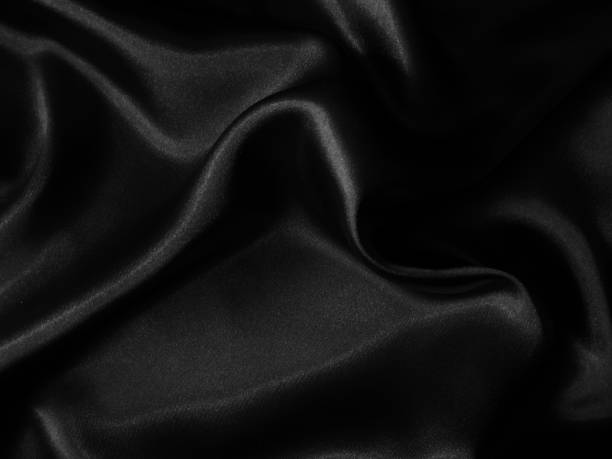istock Black crumpled shiny fabric background 1223430651