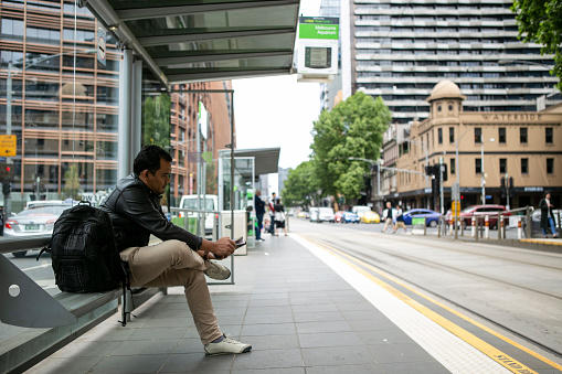 traveler man at bus stop in Melbourne city