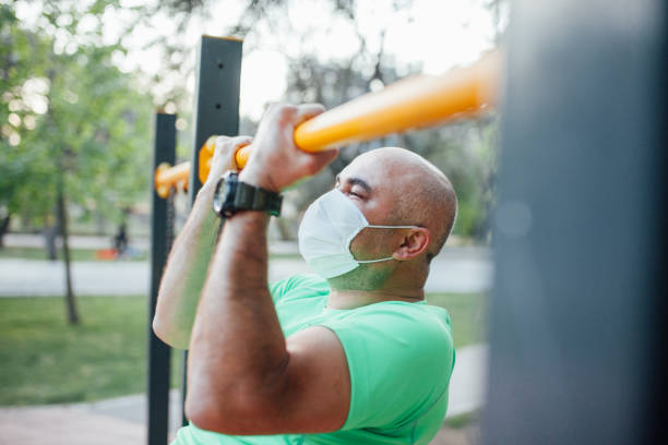 istock Man working out in a park wearing protect mask 1223431298