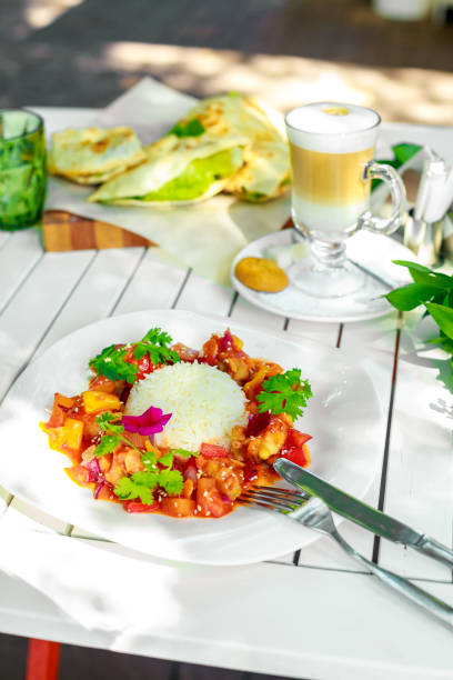 istock chicken slices in spicy sauce with bell pepper and rice 1223431944