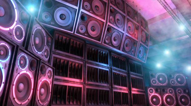 Mega sound system: loudspeakers and subwoofers in a music club Loudspeakers and subwoofers stacked on each other inside an underground music club illuminated by blue and magenta lights, with foggy and smokey atmosphere. Punk and hard rock music background. Powerful sound system. Digitally generated image. subwoofer photos stock pictures, royalty-free photos & images