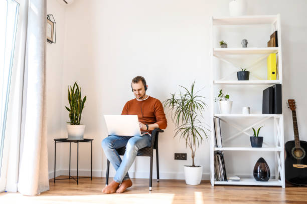 istock Guy uses headsets and laptops to work at home 1223437593