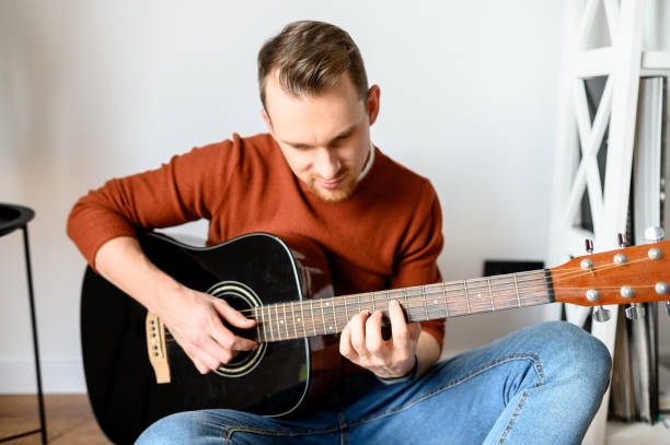 istock Young attractive guy with an acoustic guitar 1223437608