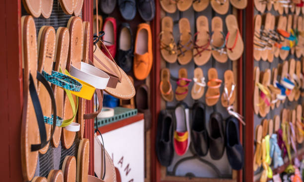 Italian street market selling quality leather handmade shoes and sandals in Positano on a summer day in Italy, Amalfi. POSITANO, ITALY - April 21 2018: Italian street market selling quality leather handmade shoes and sandals in Positano on a summer day in Italy, Amalfi. colorful handmade italian shoes stock pictures, royalty-free photos & images