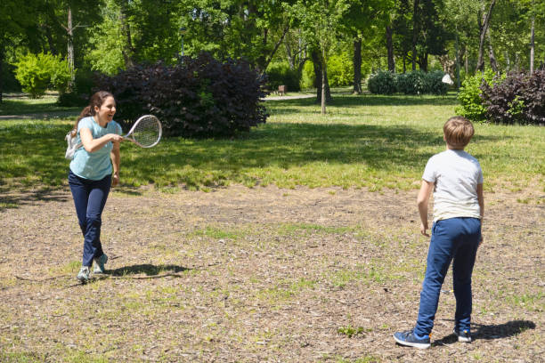 istock Boy playing badminton with mother 1223439326