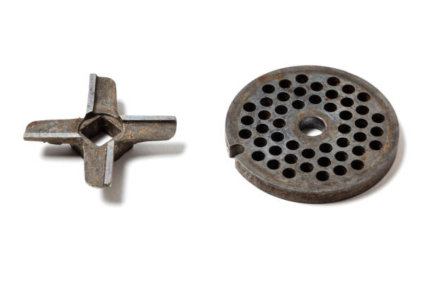 Old rusty meat grinder knives on a white background. Cleaning and sharpening