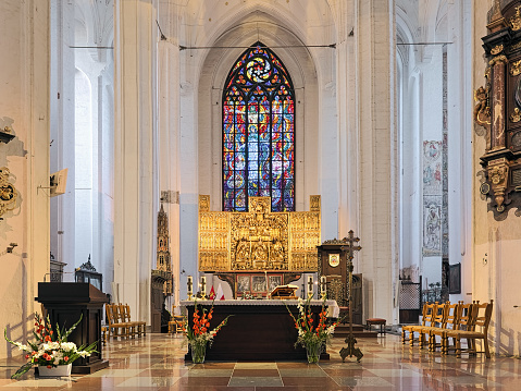 Gdansk, Poland - August 5, 2019: Altar of St. Mary's Church (Basilica of the Assumption of the Blessed Virgin Mary). The Coronation of the Blessed Virgin Mary retable was created in 1511-1517 by master Michael of Augsburg.