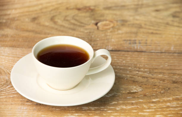 istock Cup of coffee on wooden table 1223441661