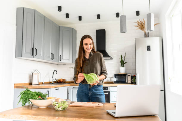 istock Woman watching cooking video in the kitchen 1223442154