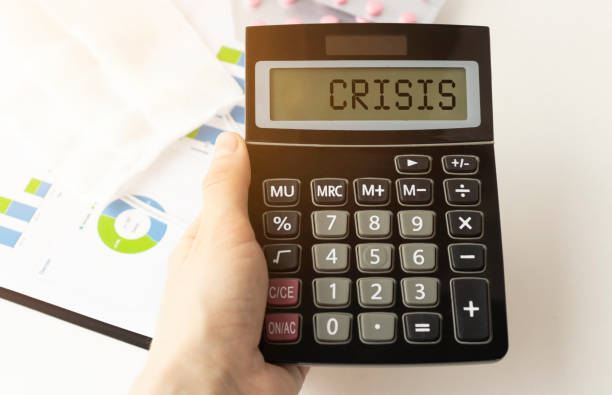 istock A calculator with the inscription CRISIS is placed in the stack of documents. Business concept 1223444531