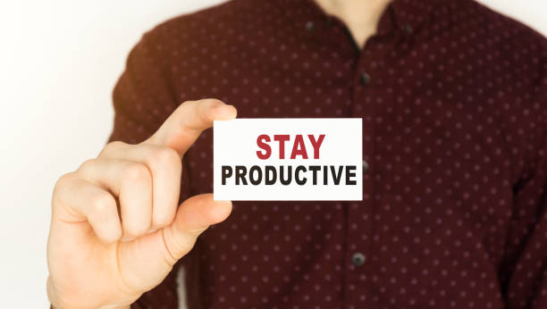 istock Businessman holding a card with text STAY PRODUCTIVE. 1223444571