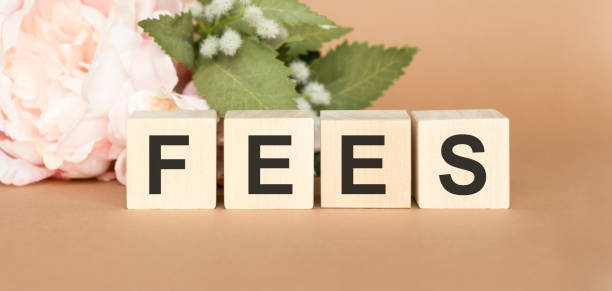 istock Cubes dice with fees on wooden background 1223444595