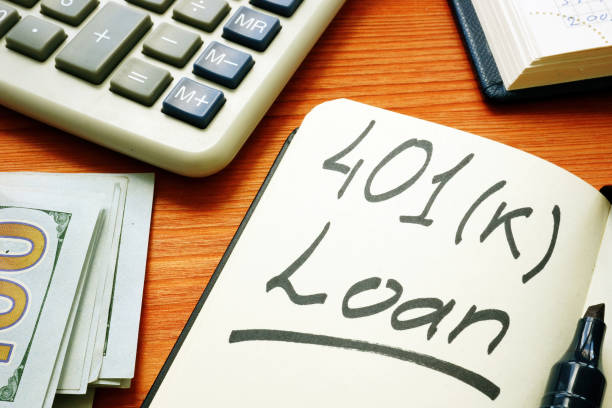 istock 401k loan phrase in the notepad and calculator. 1223446543