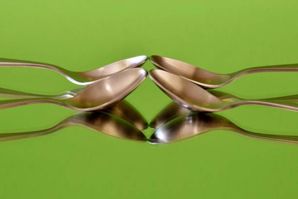 Reflected Spoons On Green