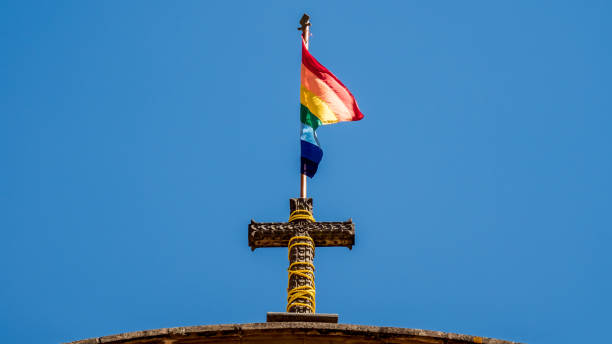 flag of cusco. rainbow flag on top of a church flag of cusco. rainbow flag on top of a church kruis stock pictures, royalty-free photos & images