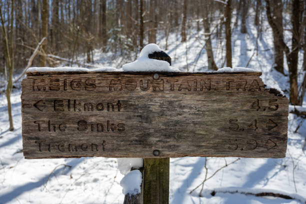 Trail markers on a snowy trail at Centennial Park in Wellesley, MA, a suburb of Boston.  The park is popular among residents for hiking and dog walking.