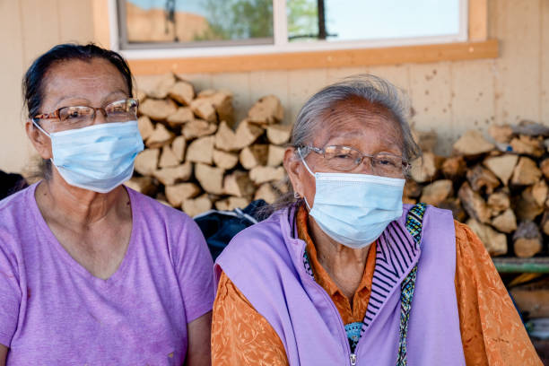 Two Elderly Navajo Women Wearing Face Masks To Protect Them From Getting The Coronavirus Two Navajo women over the age of 60 wearing masks are at high risk of contracting the Covid19 virus, Monument Valley, Navajo Nation Territory navajo nation covid stock pictures, royalty-free photos & images