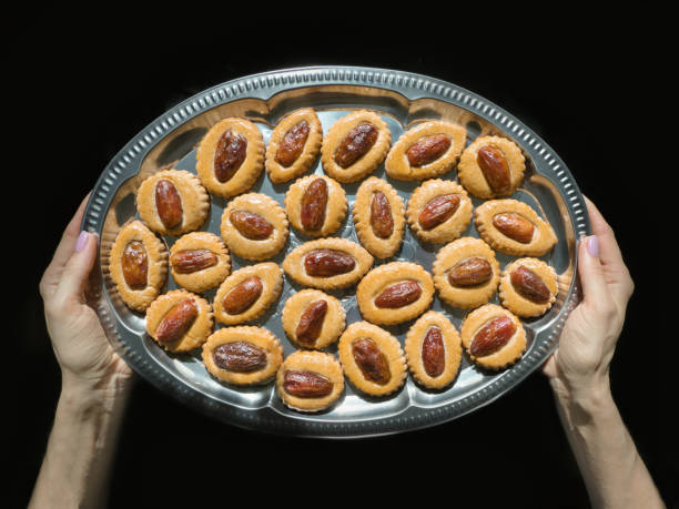istock Homemade Eid Dates sweets on a tray in hands. 1223456389