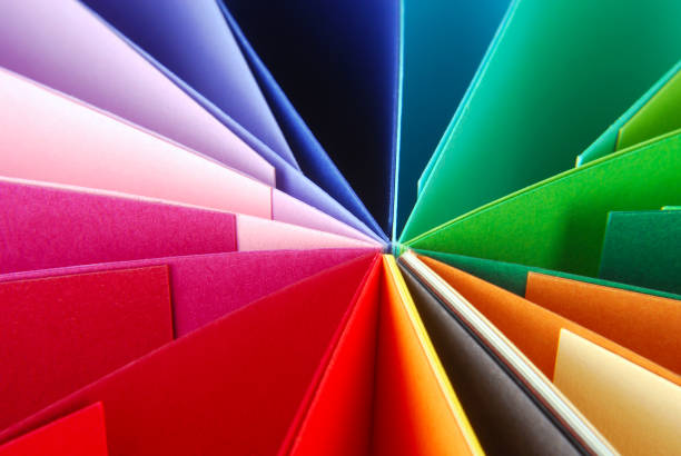 Overhead shot of abstract multi colored paper on white background.