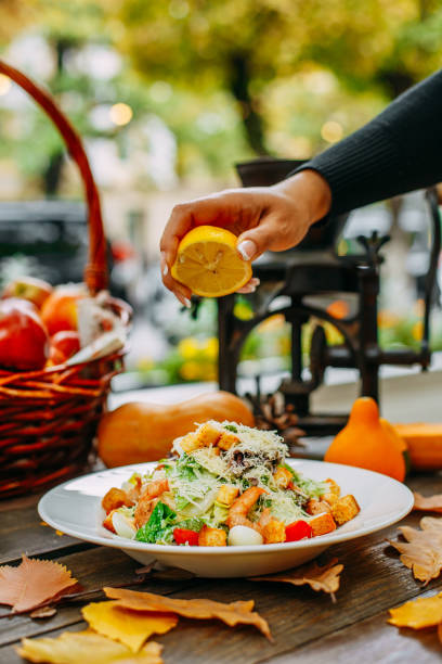 istock Autumn table setting with pumpkins. Thanksgiving dinner. shrimp caesar salad 1223456809
