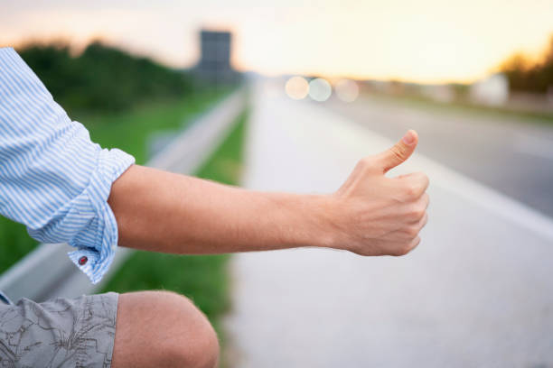 istock Male hand raised for hitch-hike 1223457820