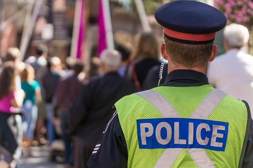 Back of a Police Officer Overlooking an Event