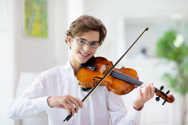 Man playing violin. Classical music instrument. Man playing violin. Classical music instrument. Teenage boy practicing viola. Teenager art school student. violinist photos stock pictures, royalty-free photos & images