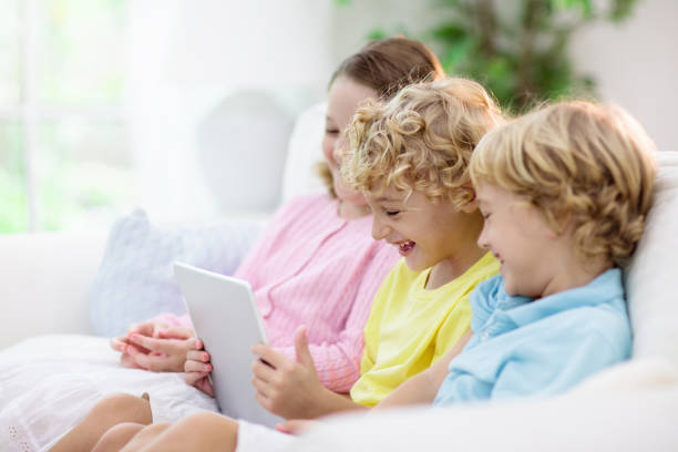 istock Kids with mobile phone. Child with tablet computer 1223459589