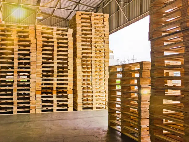 Photo of Wooden pallets stack at the freight cargo warehouse for transportation and logistics industrial