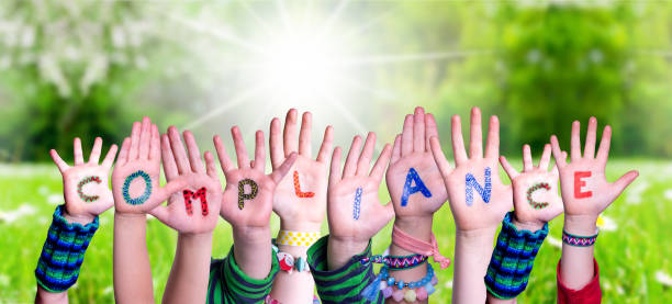 istock Children Hands Building Word Compliance, Grass Meadow 1223474255