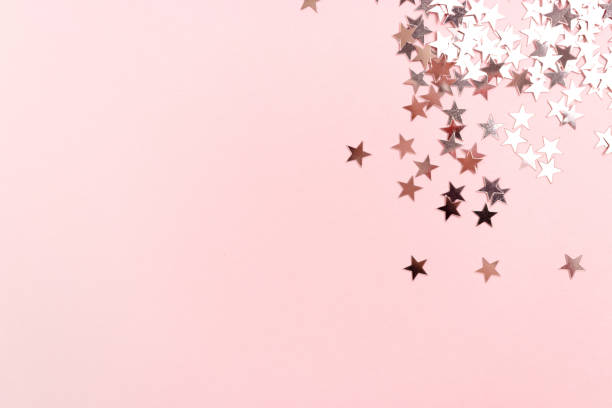 istock Stars glitter scattered on pink pastel background. Monochromatic concept. 1223475112