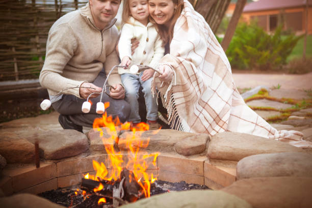 Happy family grilling marshmallow in patio
