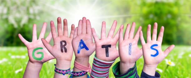 istock Children Hands Building Word Gratis Means Free, Grass Meadow 1223476571