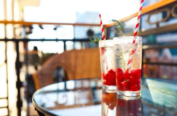 Summer refreshing lemonade with raspberry on a balcony of terrace