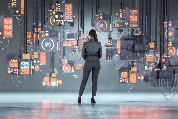 istock Woman standing against suspended computers 1223477270