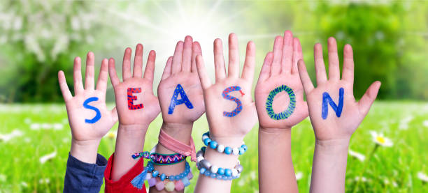istock Children Hands Building Word Season, Grass Meadow 1223477402