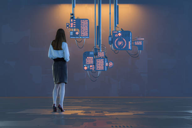 istock Woman standing against suspended computers 1223477582