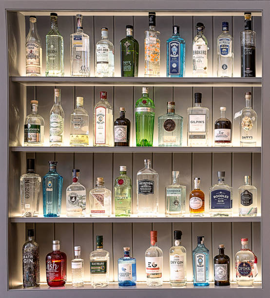 Gin O´clock A collection of perfectly positioned gin bottles in four rows gin stock pictures, royalty-free photos & images
