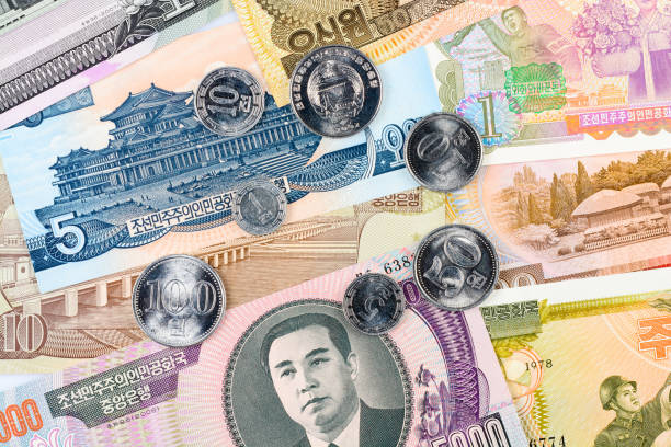 istock Seven North Korea Won coins on a different banknotes background. DPRK money close-up macro. 1223480231