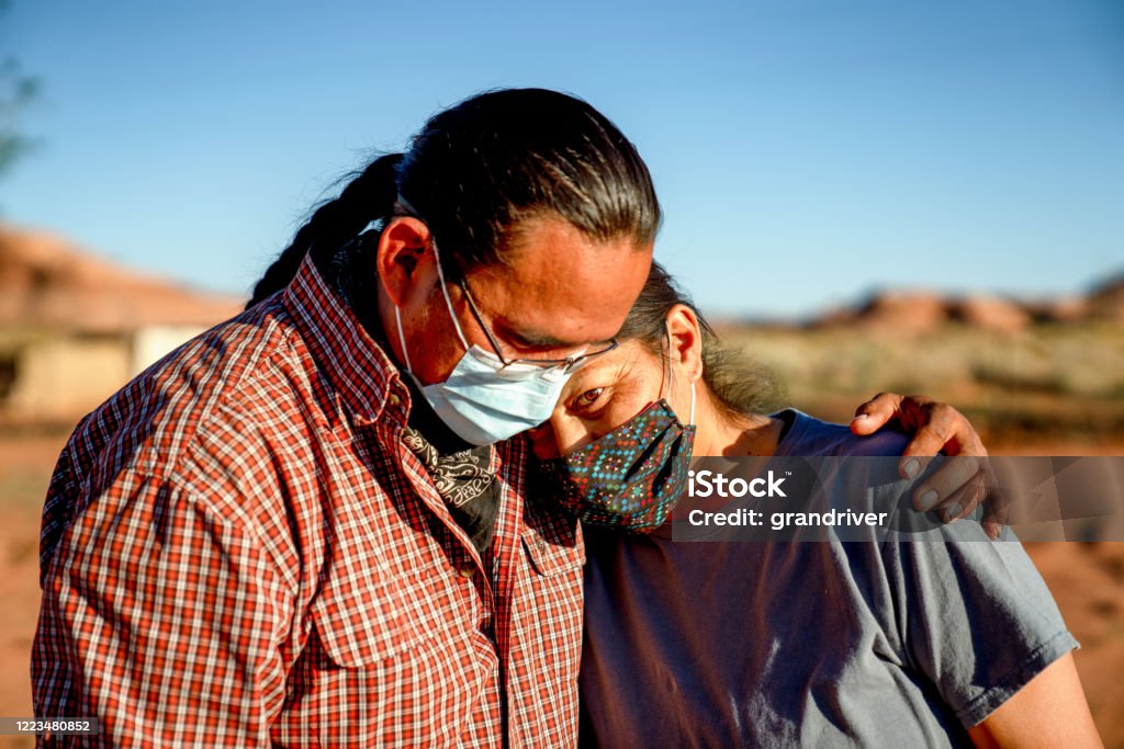 A Navajo Husband Comforts His Wife Because Of Lost Jobs And Income, Covid19 Shutdown A Navajo husband and wife encourage one another because of the Coronavirus curfew by the Tribal Council in Arizona Indigenous Peoples of the Americas Stock Photo