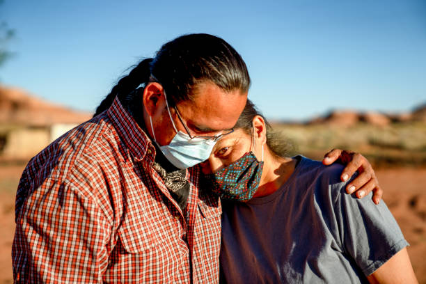 A Navajo Husband Comforts His Wife Because Of Lost Jobs And Income, Covid19 Shutdown A Navajo husband and wife encourage one another because of the Coronavirus curfew by the Tribal Council in Arizona navajo nation covid stock pictures, royalty-free photos & images