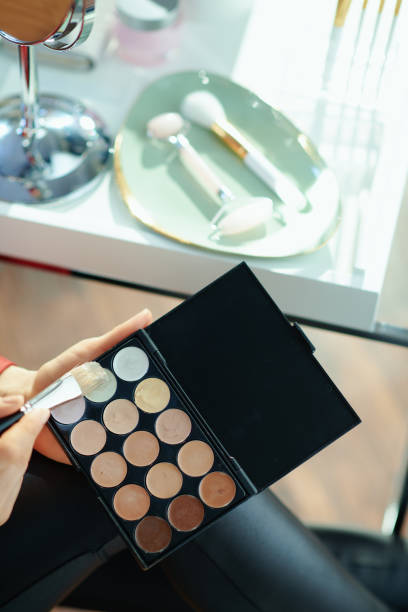 istock woman in house in sunny day using concealer palette 1223481101