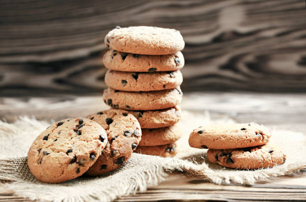 istock Chocolate cookies stack in bowl on wooden table. 1223481135