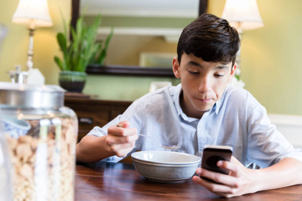 istock Teenage boy eating cereal before school 1223481338