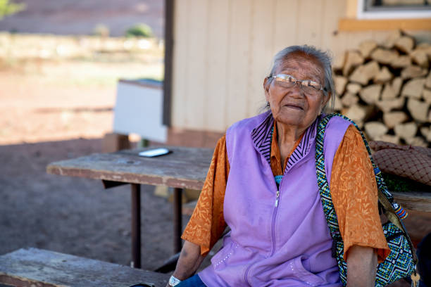 una matriarca sorridente di una famiglia navajo a casa sua nella riserva in arizona, monument valley - navajo american culture indigenous culture women foto e immagini stock