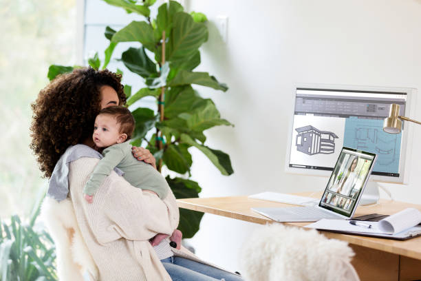 istock Female architect works from home while caring for baby 1223481453
