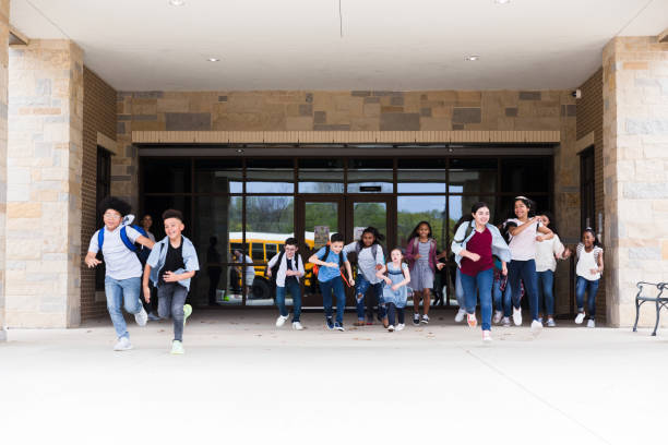 istock Excited schoolchildren leave school building 1223481534