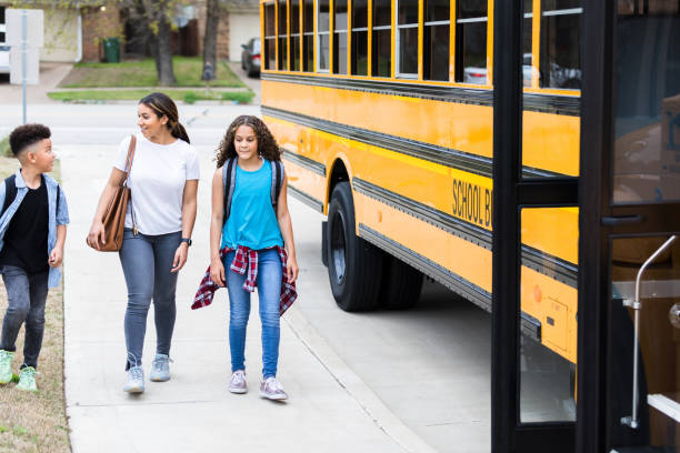 istock A mom walks her children to school bus stop 1223481582