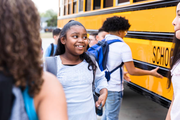 istock Beautiful schoolgirl talking with friends 1223481606