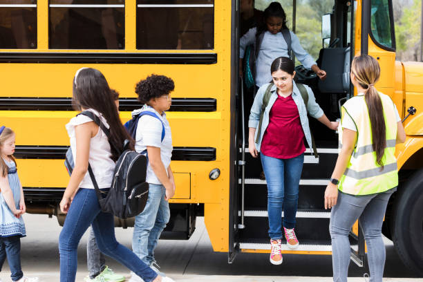 istock Children step off school bus at field trip destination 1223481664